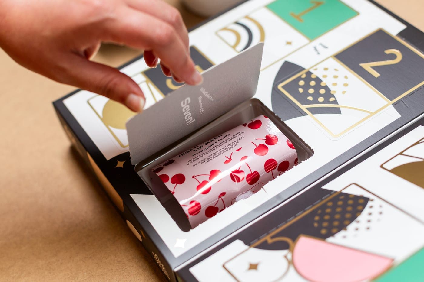 A recipient opening door one of their Seven Yays box